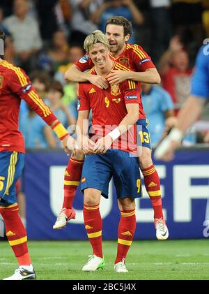 Spain's Juan Mata celebrates scoring their fourth goal by jumping on Fernando Torres' back Stock