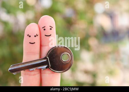 Fingers art of happy couple. Family holds house key. Stock Photo