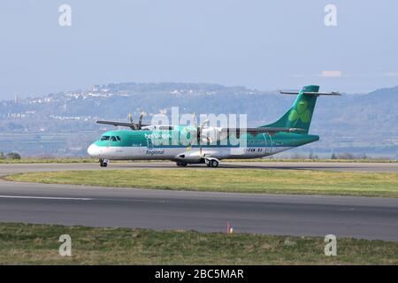 A small Aer Lingus regional airline propeller plane at Bristol International Airport about to take off on the runway Stock Photo