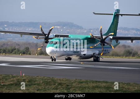 A small Aer Lingus regional airline propeller plane at Bristol International Airport about to take off on the runway Stock Photo