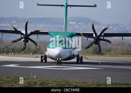 A small Aer Lingus regional airline propeller plane at Bristol International Airport about to take off on the runway Stock Photo