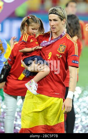 Spain's Fernando Torres celebrates victory with his daughter after the final whistle Stock Photo