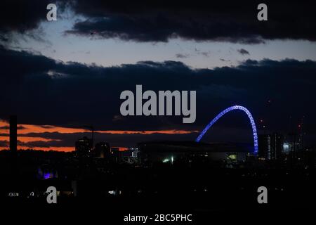 London, UK. 02nd Apr, 2020. The iconic Wembley Stadium arch lit up blue to celebrate frontline NHS workers as part of the Clap for Carers event. Credit: David Parry/Alamy Live News Stock Photo
