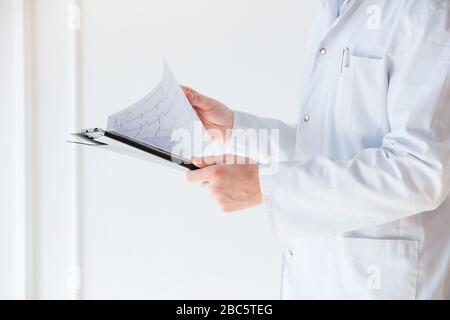 Doctor analyzing a folder picture cardiogram Stock Photo