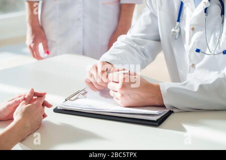 Close up of patient and doctor taking notes Stock Photo