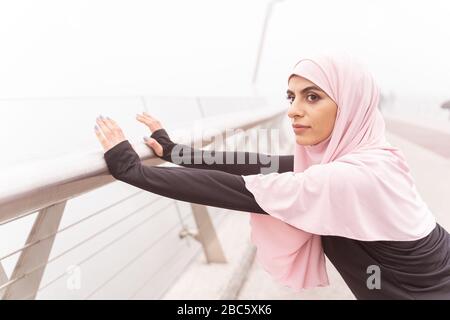Confident lady putting hands on the banister stock photo Stock Photo