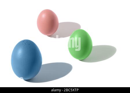 Three colored eggs with shade on white background, isometric composition, isolated Stock Photo