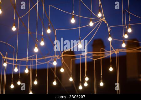 Lightbulb instalation net over city center street beautiful warm light Stock Photo