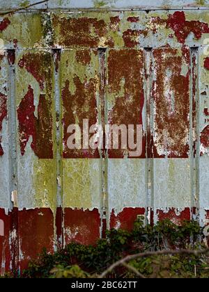 Background of rusty wall with peeling paint. Stock Photo
