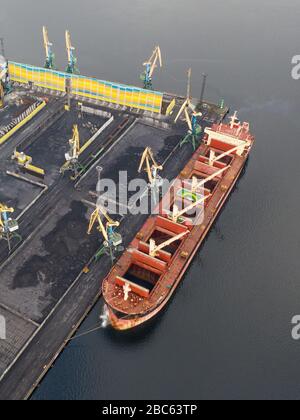 Murmansk, Russia - August 18, 2019: Vessels at the mooring of the coal terminal of the port of Murmansk. Shooting from above drone. Stock Photo