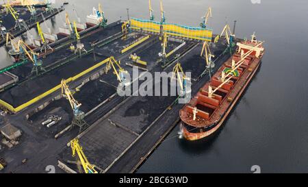 Murmansk, Russia - August 18, 2019: Vessels at the mooring of the coal terminal of the port of Murmansk. Shooting from above drone. Stock Photo