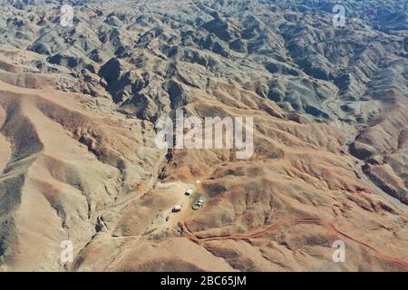 (200403) -- ALXA, April 3, 2020 (Xinhua) -- Aerial photo shows pastoral home of Ce Geng's family in Alxa Left Banner, north China's Inner Mongolia Autonomous Region, April 1, 2020.  Ce Geng, a 9-year-old fourth grader of a Mongolian School in Alxa Left Banner, moved here with her parents to look after the sheep as the shepherd they had hired from other Province failed to come back due to the COVID-19 outbreak.   The family's ranch is located near the border between China and Mongolia in the northern part of Alxa, more than 6 hours' drive from downtown Alxa Left Banner. The rocky gobi mountains Stock Photo