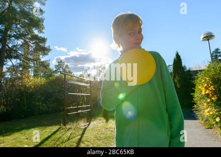 Young handsome boy playing Frisbee in the front yard Stock Photo
