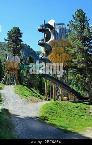 Jerzens, Austria - June 24th 2016: Zirbenpark, preferred playground and lookout with spiral slide in hiking area Hochzeiger mountain Stock Photo