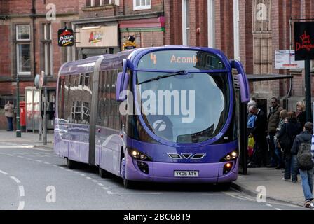 A  bendy bus in service in one of the narrow streets of York, in Yorkshire, Britain Stock Photo