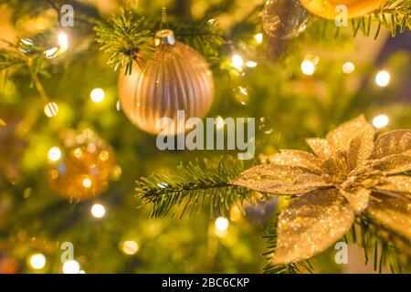 Decorated Christmas tree on blurred background. Holiday closeup, golden decoration Stock Photo
