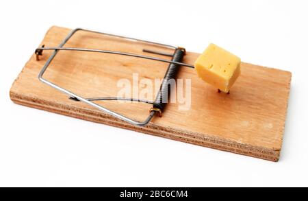 mouse trap with a piece of cheese on a white background close-up Stock Photo