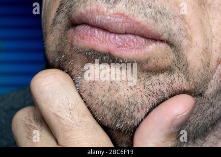 Closeup Portrait Of A Bearded Man With Hand On Face Stock Photo