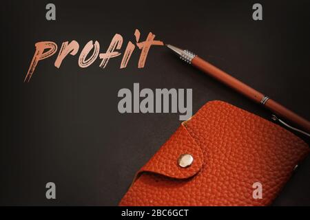 Profit word, a pen and wallet on dark background. Business startup profit concept Stock Photo