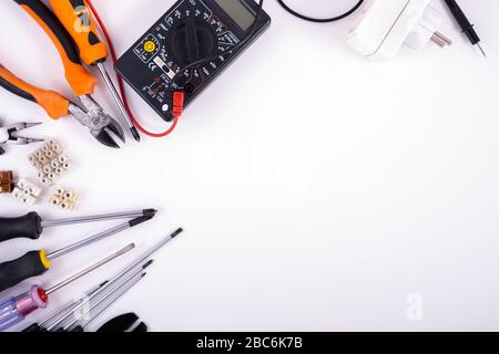 Electrician equipment. Top view. Close up of work tools and components for residential electrical installation isolated on white background Stock Photo