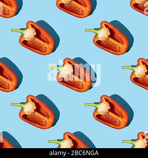 Seamless pattern of half red pepper with shadow on blue color background. Flat lay, Food texture. Stock Photo