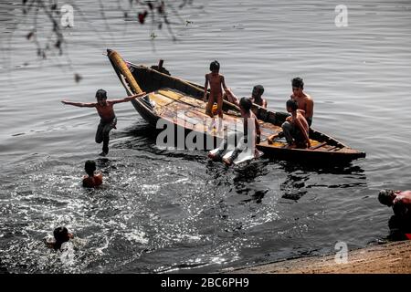 Dhaka, Bangladesh. 30th Mar, 2020. Some of kids are playing in black-polluted water of the Buriganga River. (Photo by Jahangir Alam/Pacific Press) Credit: Pacific Press Agency/Alamy Live News Stock Photo