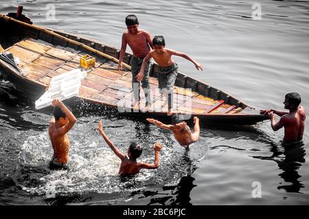 Dhaka, Bangladesh. 30th Mar, 2020. Some of kids are playing in black-polluted water of the Buriganga River. (Photo by Jahangir Alam/Pacific Press) Credit: Pacific Press Agency/Alamy Live News Stock Photo