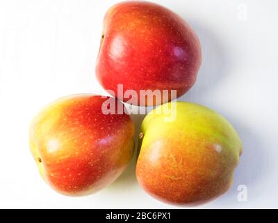 Three braeburn apples from above on a white tablecloth Stock Photo