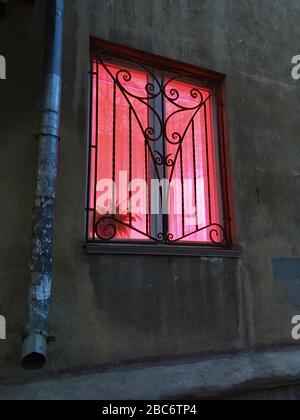 Lamp for plants, phytolamp. View from the street to the pink light from the window. Artificial lighting plantings. Without people. Spring Stock Photo