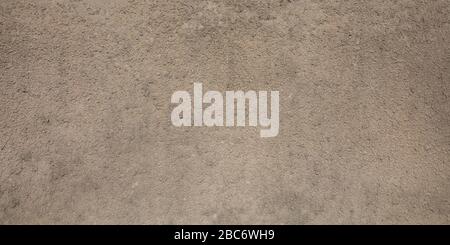 gray beige porous granular wall background texture with paint color rough surface plaster Stock Photo