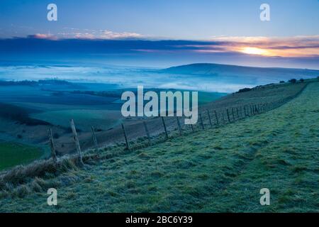 Misty morning sunrise over the south downs in east sussex England from Bo Peep Stock Photo