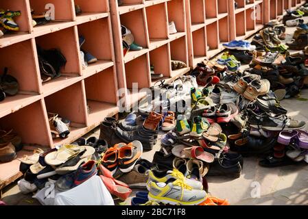 Scattered shoes at out side of temple Stock Photo