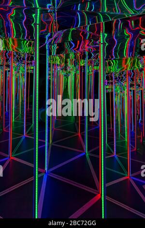 Inside the attraction "Mirror Maze" with LED multi-colored backlight. Stock Photo