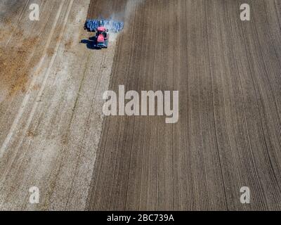 03 April 2020, Mecklenburg-Western Pomerania, Brüsewitz: A crawler tractor pulls a harrow over a field and prepares the field for sowing. The dry and sunny weather is used by the farmers to cultivate the fields in spring. Photo: Jens Büttner/dpa-Zentralbild/dpa Stock Photo