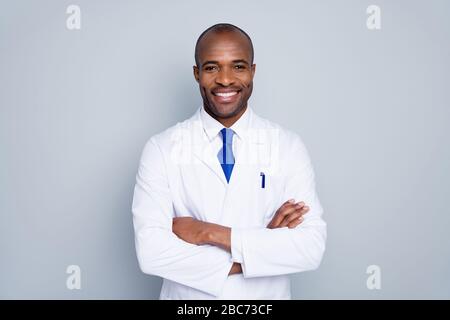 Photo of cheerful doctor dark skin guy virologist agent corona virus seminar conference arms crossed pandemic virus expert wear white lab coat tie Stock Photo