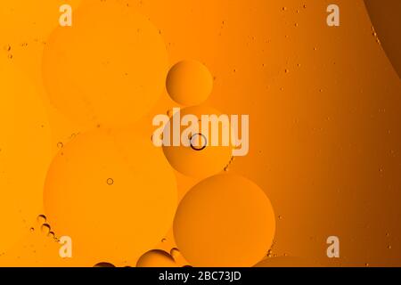 Abstract background from mixed water and oil bubbles in orange color Stock Photo