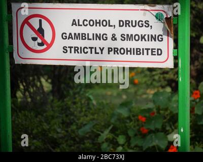 New Delhi, India- March 2018: Close up of a sign at the Lodi Gardens prohibiting smoking, gambling, alcohol and drugs. Stock Photo