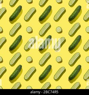 Seamless pattern of cucumbers on yellow background. Flat lay, Food vegetables texture. Stock Photo