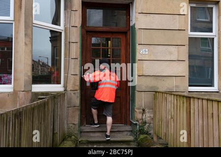 Glasgow, Scotland, UK. 3 April, 2020. Images from the southside of Glasgow at the end of the second week of Coronavirus lockdown. Pictured; Royal Mail postman making deliveries in Shawlands. Iain Masterton/Alamy Live News Stock Photo