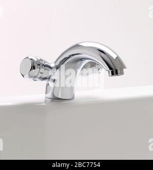 Close-up of chrome water tap in the bathroom sink Stock Photo