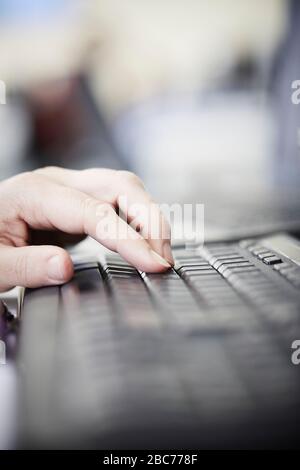 Image of man's hands typing on computer keyboard Stock Photo