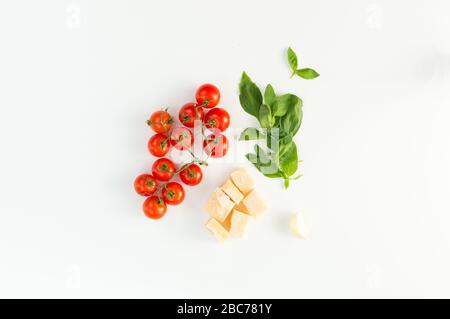 Italian red tomatoes close up food with pasta, basil leafs, cheese, isolated on white background - Top view Stock Photo