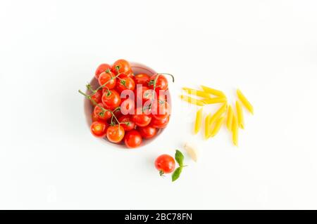 Italian red tomatoes close up food with pasta, basil leafs, cheese, isolated on white background - Top view Stock Photo