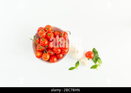 Italian red tomatoes close up food with pasta, basil leafs, cheese, isolated on white background - Top view Stock Photo