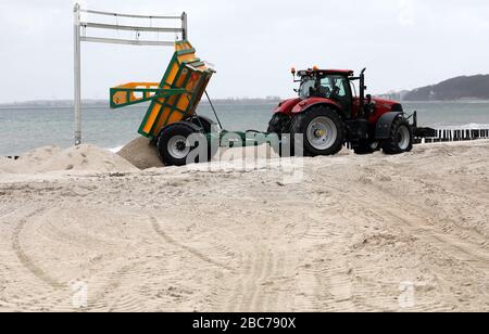 03 April 2020, Mecklenburg-Western Pomerania, Kühlungsborn: On the Baltic Sea beach behind the marina sand is transported, which has been blown by the wind in other places in the past weeks and months. Photo: Bernd Wüstneck/dpa-Zentralbild/ZB Stock Photo