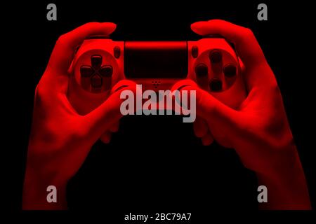 Hyman hands video game gamepad in neon lights isolated on a black background with clipping path Stock Photo