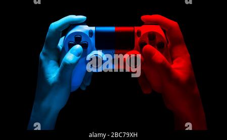 Hyman hands video game gamepad in neon lights isolated on a black background with clipping path Stock Photo