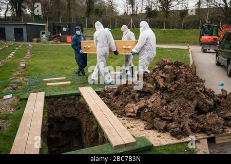 undertakers wearing personal protective equipment carry the coffin to the gravesite during the funeral in Chislehurst of Ismail Mohamed Abdulwahab, 13, from Brixton, south London, who died alone in King’s College Hospital in the early hours of Monday after testing positive for the coronavirus. Stock Photo