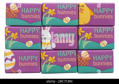 Happy bunnies milk chocolate bars set on white background, ideal for Easter - Easter chick chicks, Easter bunny bunnies, Easter egg eggs & daffodils Stock Photo