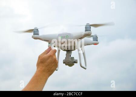 Male hand holds a working quadrocopter Stock Photo
